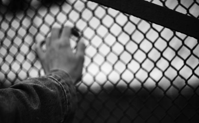 Liana S hand on fence unsplash