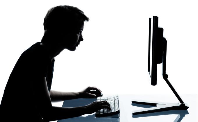 young boy looking at the computer