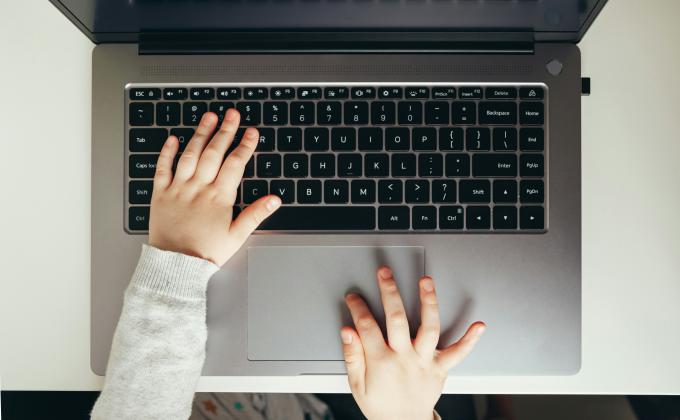 baby hands on a laptop